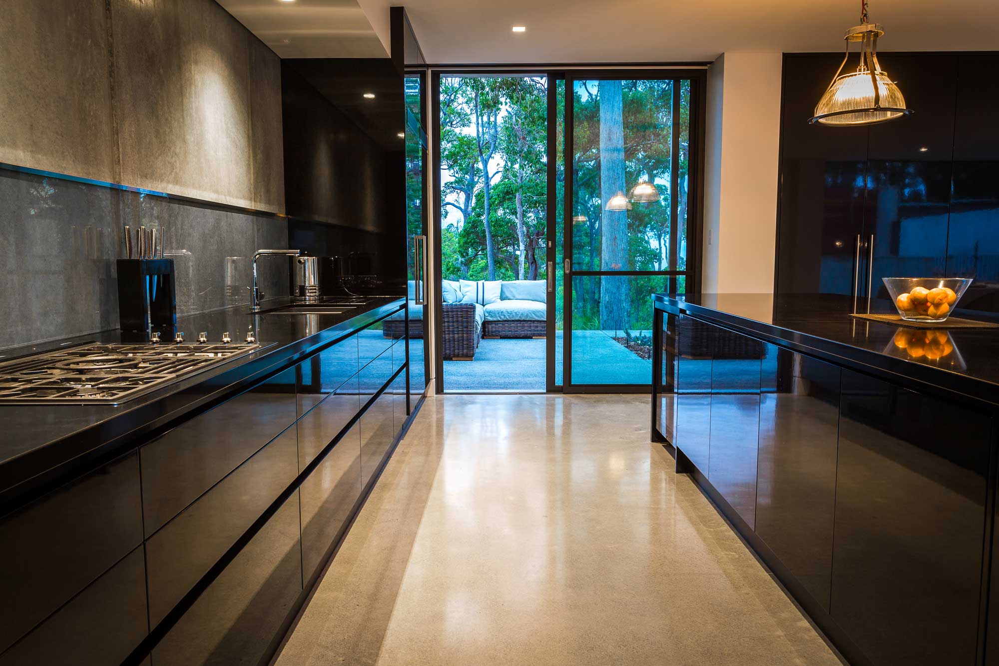 black gloss kitchen with reclaimed light fittings