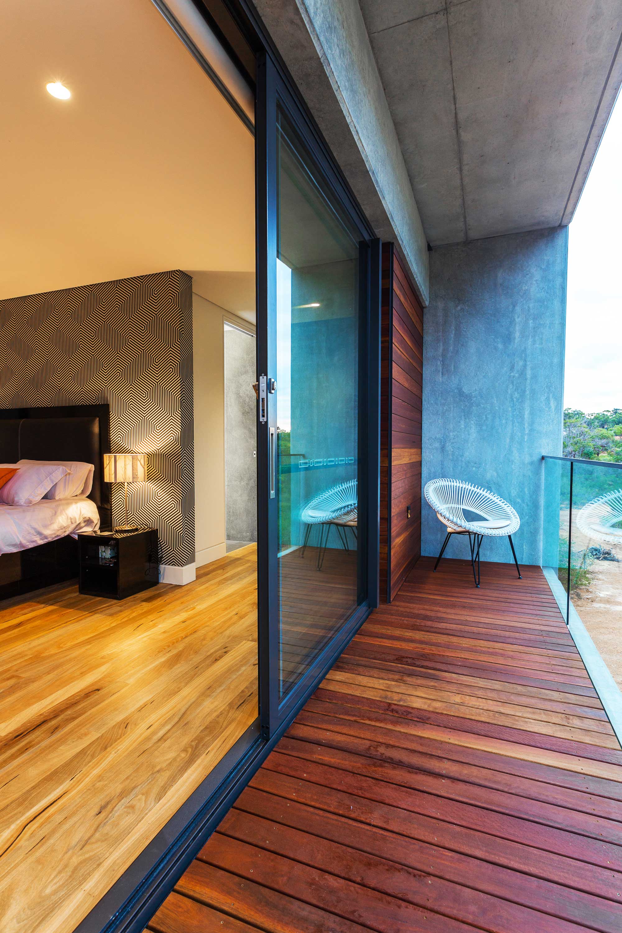 bedroom with monochrome wallpaper and marry flooring